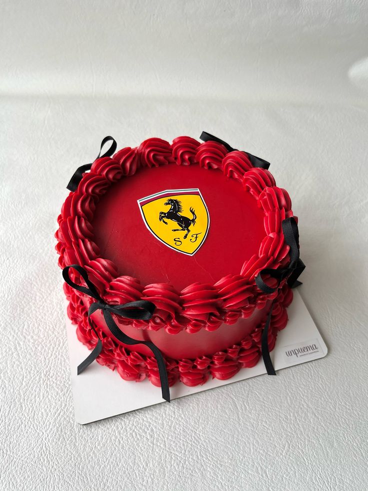 Red cake with Ferrari logo on a white background
