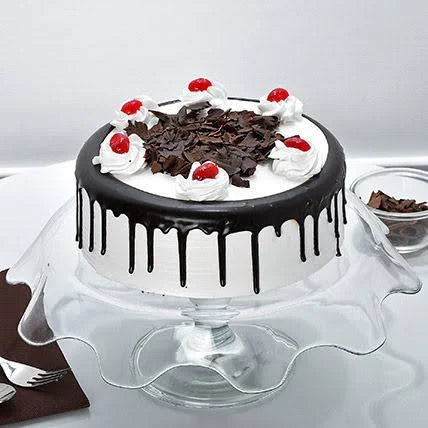Chocolate cake with white frosting and cherries