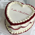 Heart-shaped cake with red and white icing